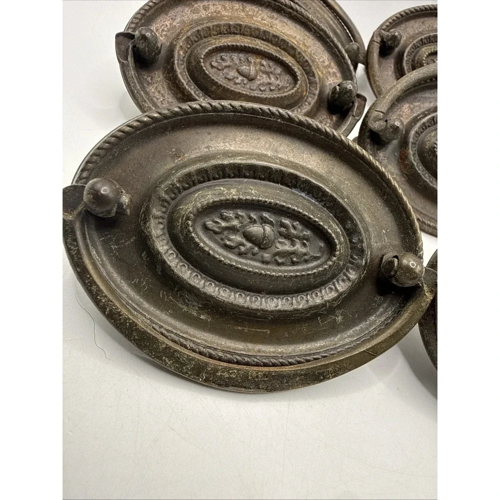 Antique Hepplewhite-style drawer pulls embossed oval backplate